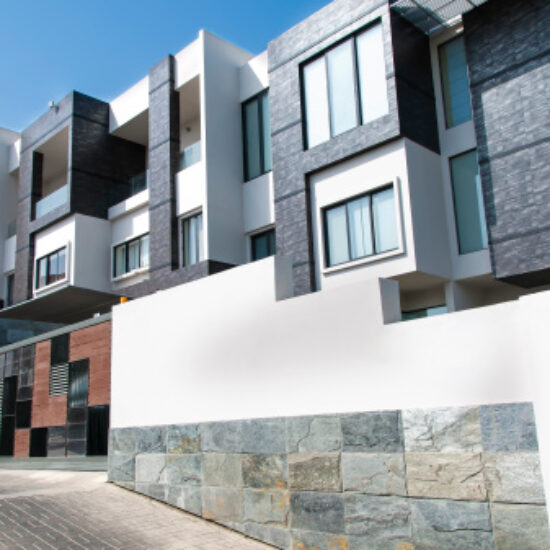 A row of modern multi-story residential units in an urban setting.